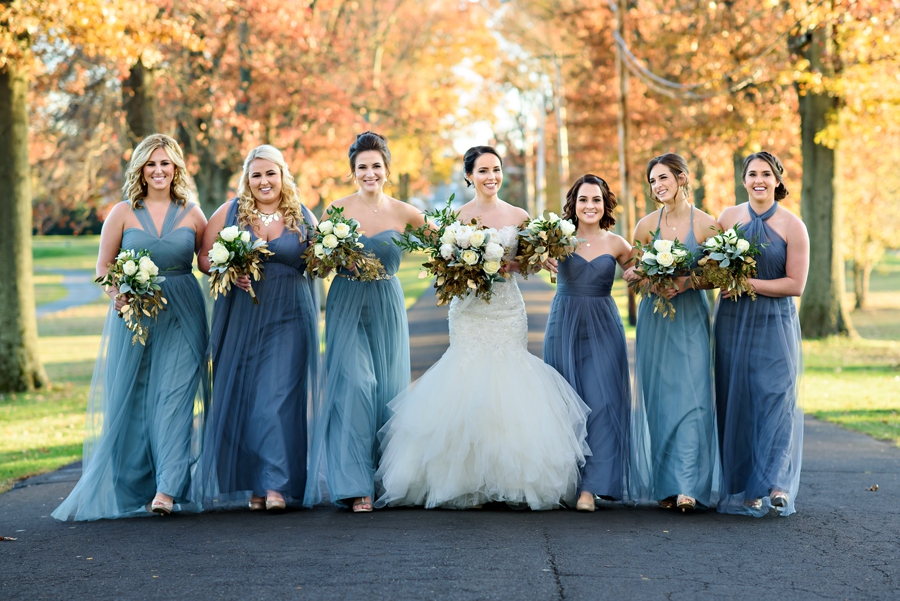 Bridesmaids walk the bride to the ceremony.